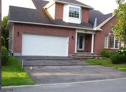 Asphalt driveway replaced with interlock paving — before