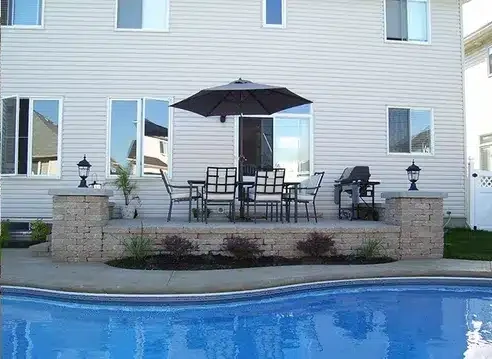 Bare pool surround rebuilt as a finished patio — after