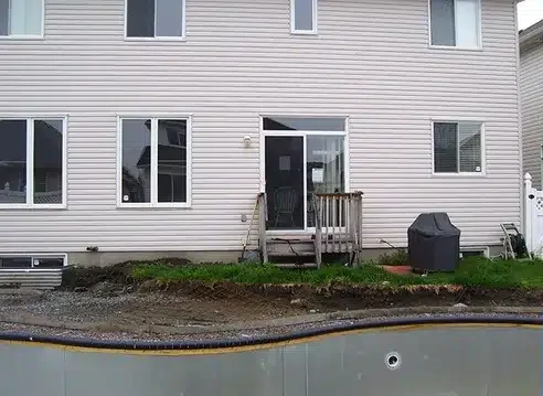 Bare pool surround rebuilt as a finished patio — before
