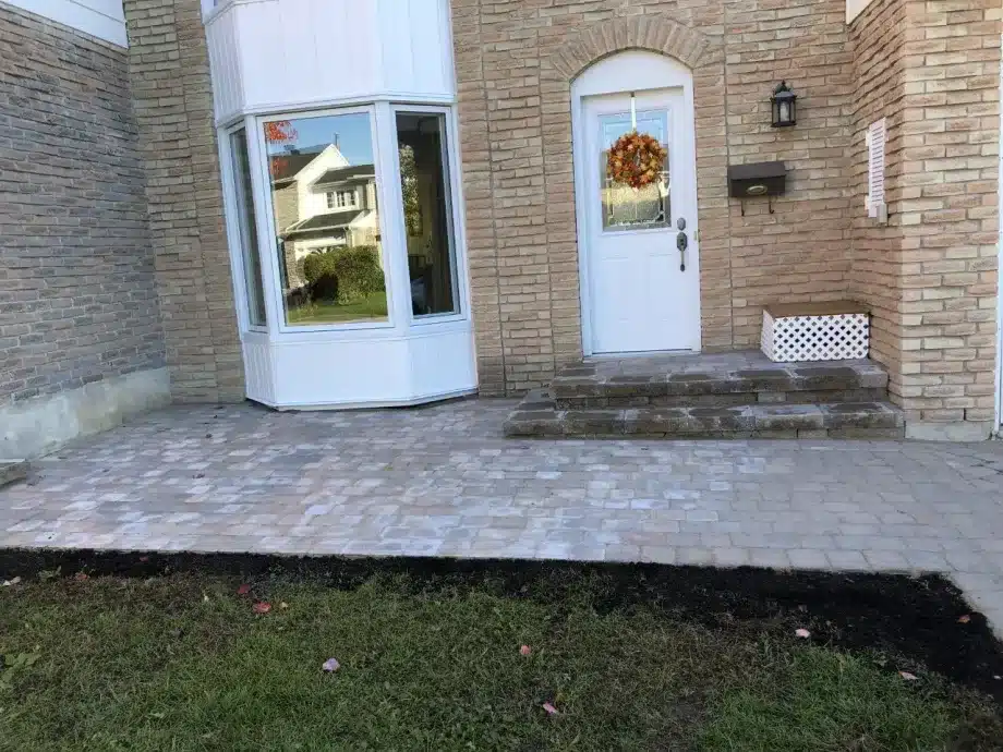Completed backyard patio with fire pit built by Authentic Landscape