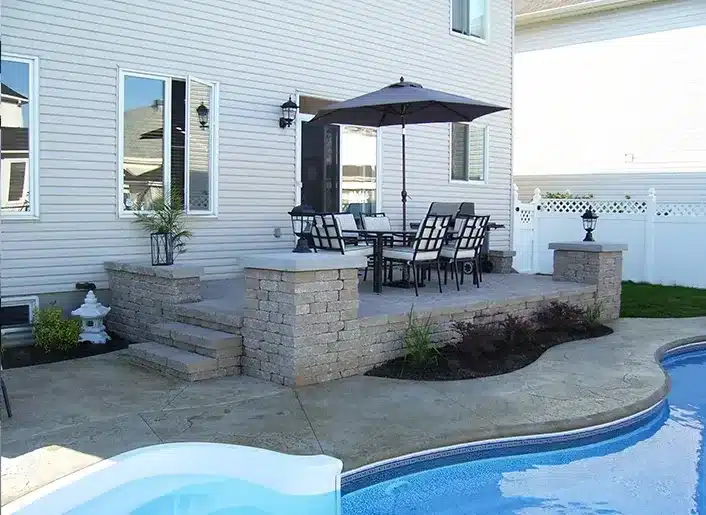 Authentic Landscape — finished backyard patio and pool surround