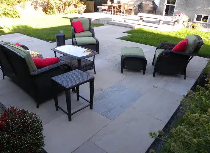 Backyard patio with seating area and stone borders