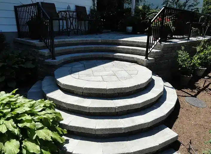 Curved natural stone steps at a front entrance