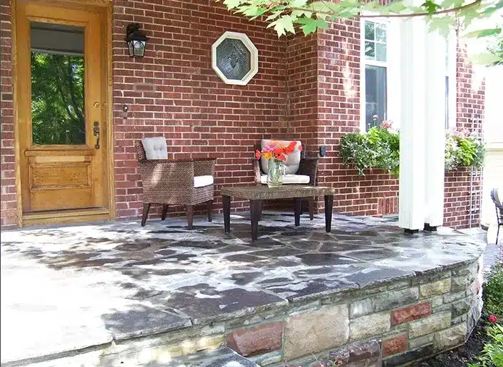 Natural stone patio at the front of a home