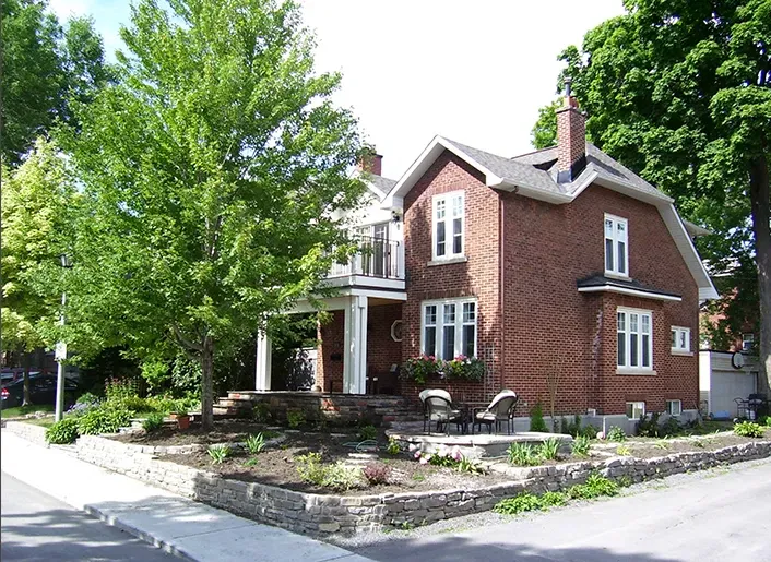 Landscaped front yard with retaining wall and planting beds