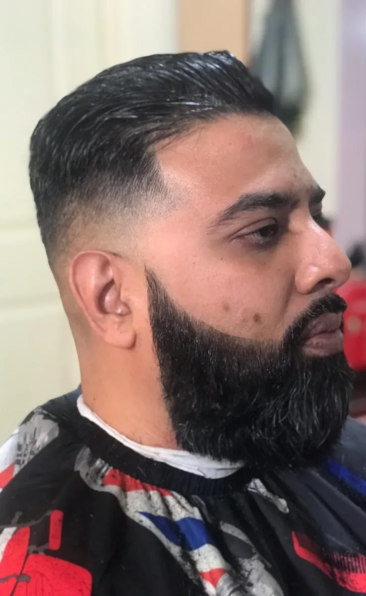 Toronto Barbers concept — barber finishing a precision fade